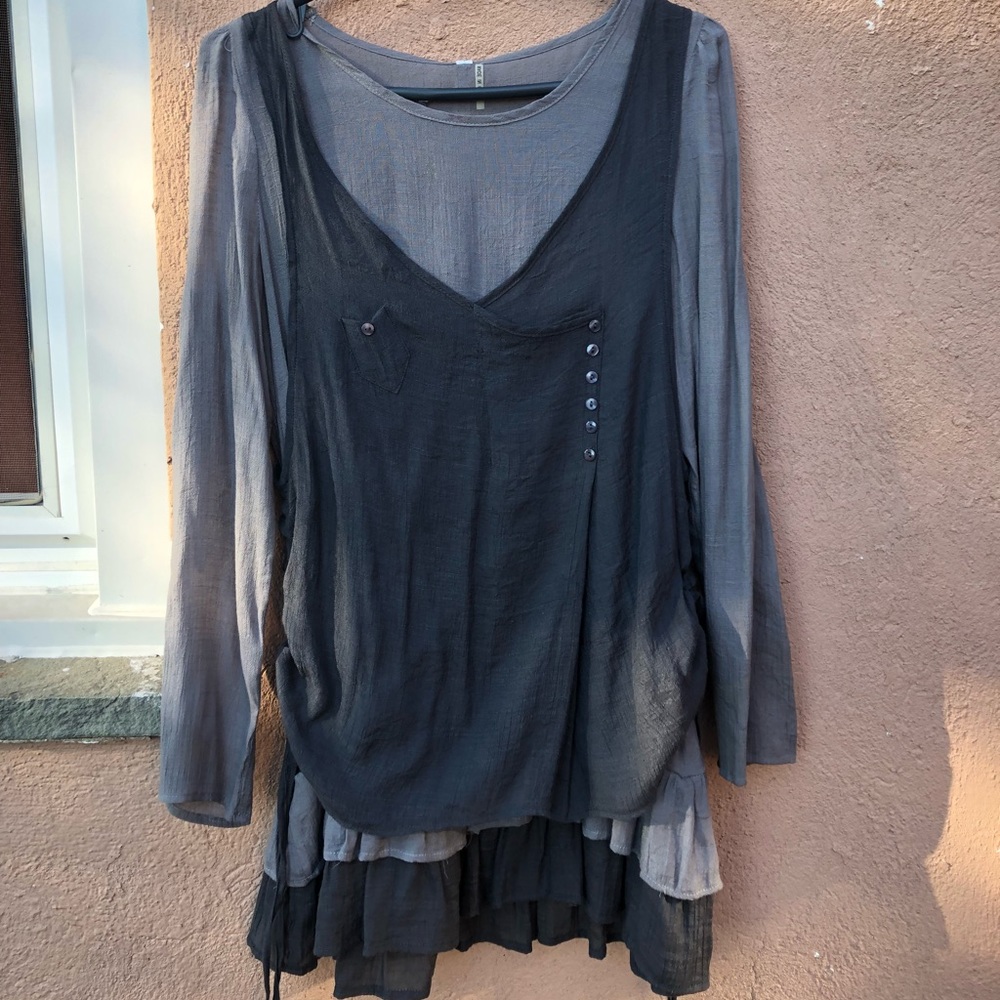 Grey blouse with buttons in the front and back.
